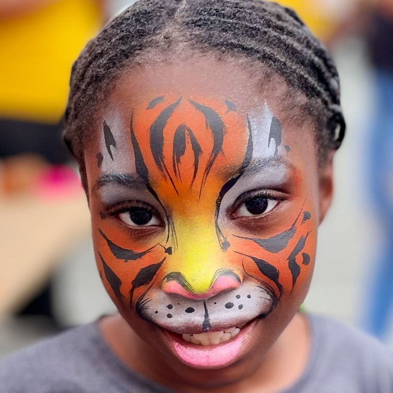 A girl with a tiger face paint, kent